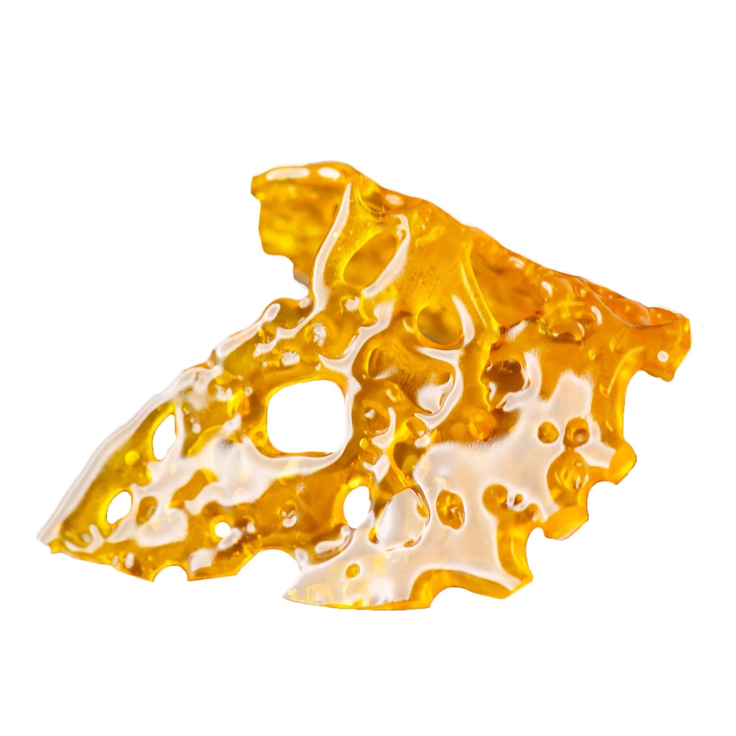 Amber-colored cannabis shatter broken into pieces, showcasing purity and clarity.